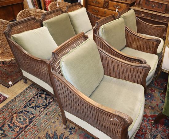 A 1920s carved beech four piece bergere suite